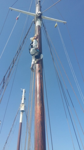 Climbing the mast to do some painting.